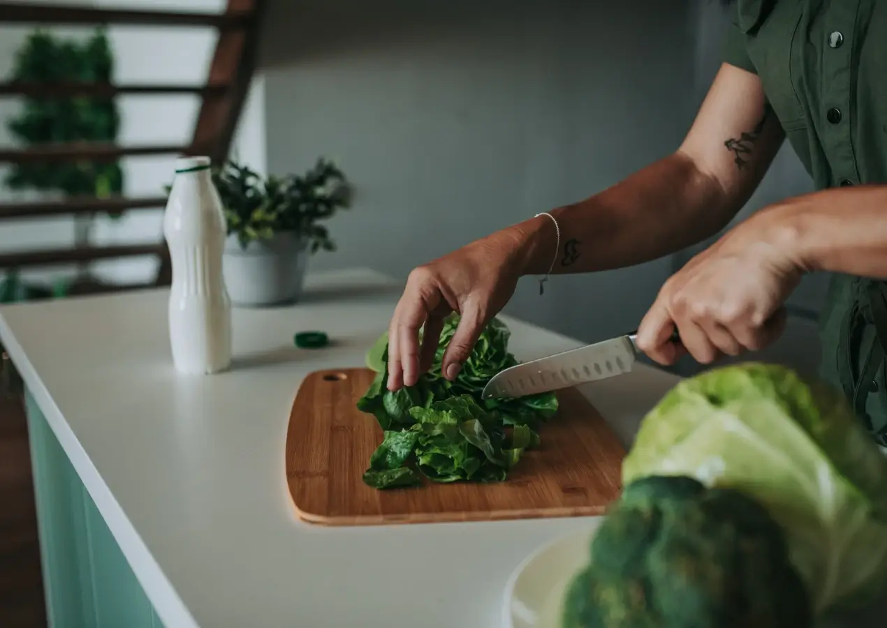 closeup of woman cutting cabbage